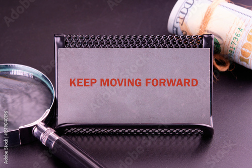 Business, motivation and keep moving forward concept. KEEP MOVING FORWARD written close-up on a gray business card
