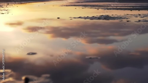 Sunset Sky Reflected in Calm Water with Rocks