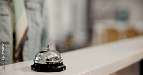 Hotel, reception desk and hand with bell to press, request help and urgent attention for service. Closeup, person and buzzer while waiting for booking, reservation or concierge signal for hospitality