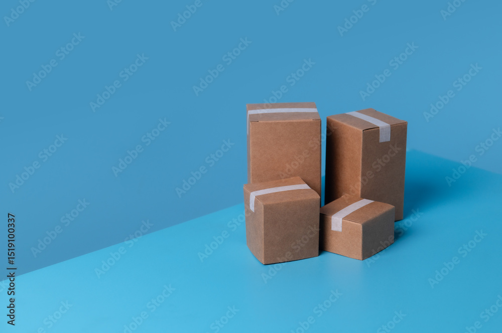 Fototapeta premium Stacked cardboard boxes against a blue background
