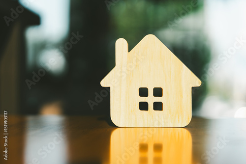 Tableau sur toile Wooden house model on wood background, a symbol for construction , ecology, loan, mortgage, property or home