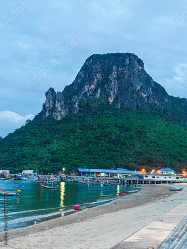 030625026 Evening view of a bay with fishing boats and large mountain. Ao Noi Sea view Prachuap Khiri Khan