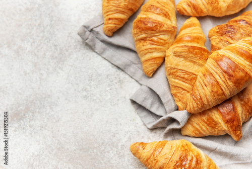 Fotografija Freshly baked croissants resting on a gray cloth napkin