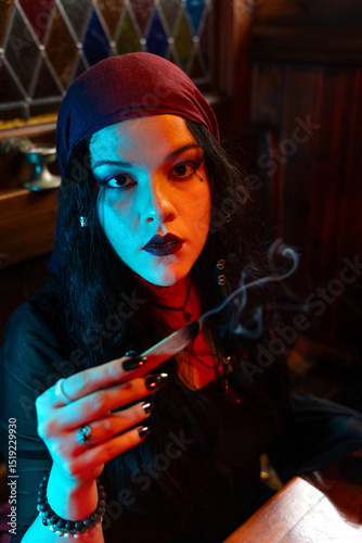Fortune teller reading a smudge stick in a mystical atmosphere