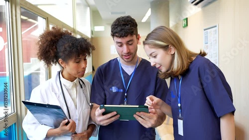 Wallpaper Mural Medical team collaboration, analyzing patient data on tablet in hospital corridor Torontodigital.ca
