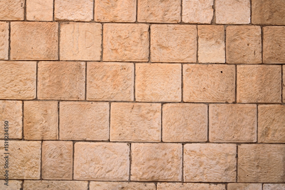 Naklejka premium Brick wall texture. Orange yellow red brick building wall, Iraq, Middle East