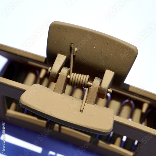 Close up brown hair claw spring object isolated on square white colored background.