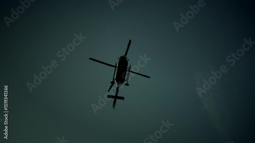 Silhouette of a Helicopter Formed Against a Dark and Ominous Sky at Dusk or Twilight Hour
