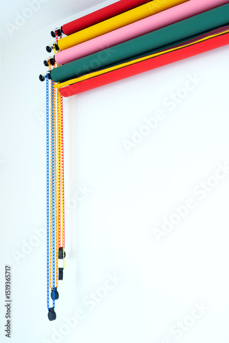holders for paper roll backgrounds with fan system on a white wall, photo studio
