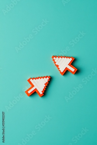 Two pixelated computer cursor arrows made of white and orange blocks on a bright turquoise background symbolizing digital technology and interaction