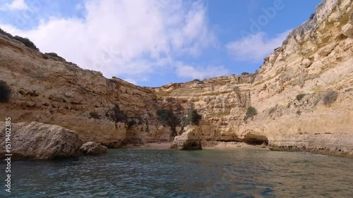 Hidden Beach Inside Limestone Sea Cave Accessible Only By Boat in Algarve Portugal