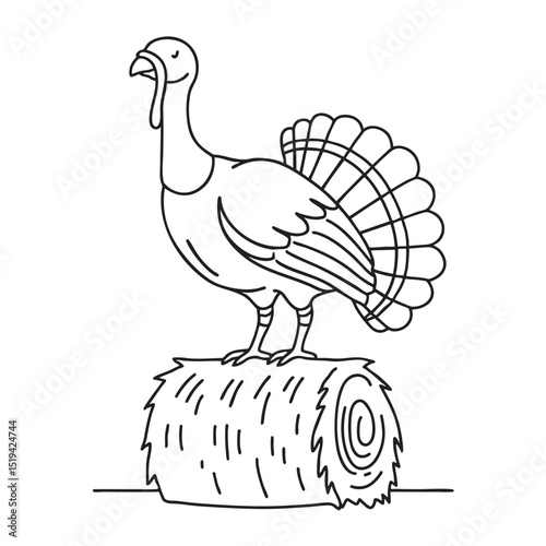 A turkey perched on a bale of hay