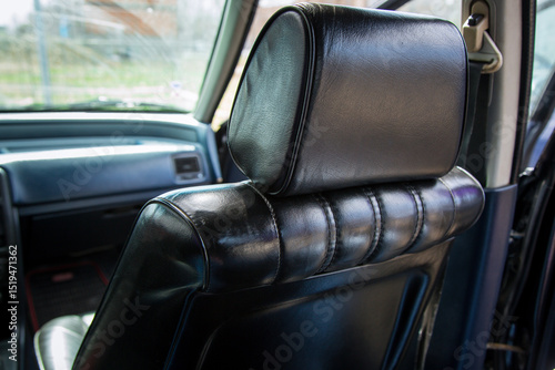 Shiny Black Leather Armchairs Inside Vintage Car – Classic Automotive Interior Design