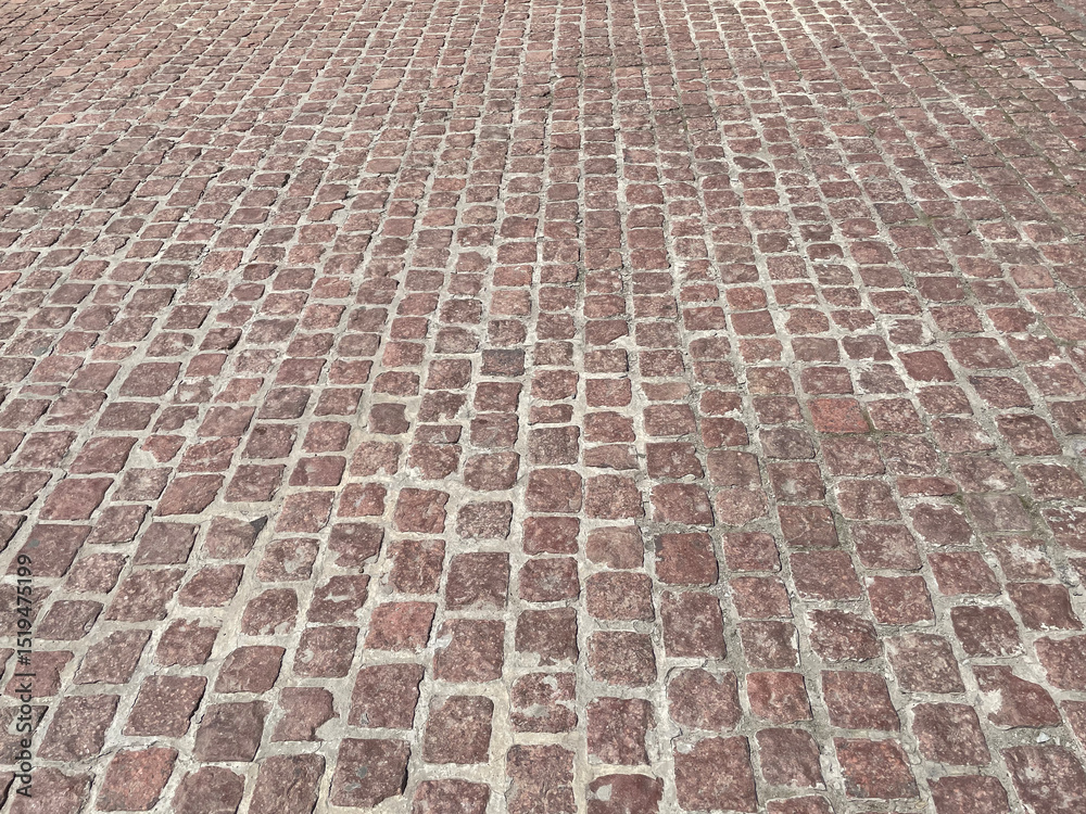 Fototapeta premium Abstract background. Old cobblestone pavement closeup