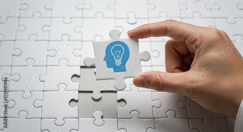 Hand holding the final puzzle piece to connect a teamwork business solution