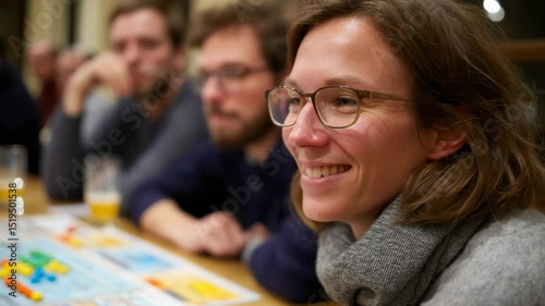 Group of friends gathered around a table, engaging in a lively board game while sharing drinks. Smiles and friendly banter fill the room, creating a warm atmosphere of connection