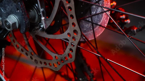 new dark gray bike for teenagers with gear shifting and disc brakes indoors illuminated with red light