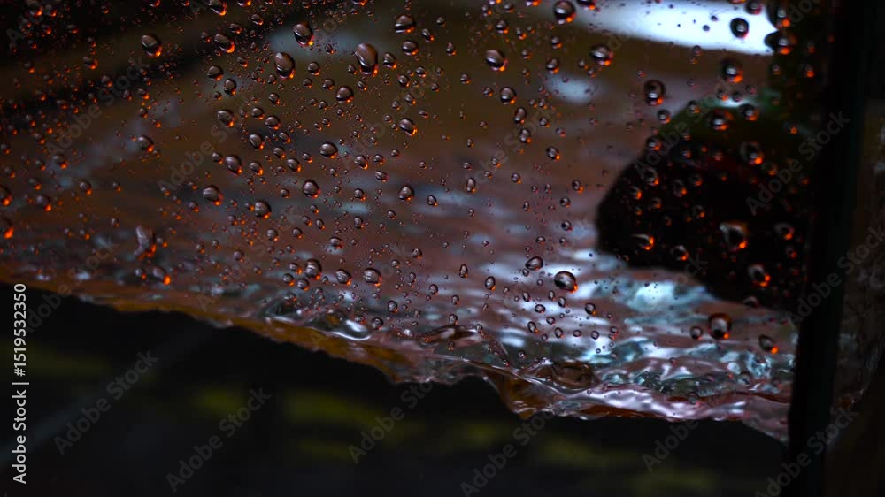 The texture of the water is a rumbling chaos with bubbles created by the air escaping outside in the blue light.