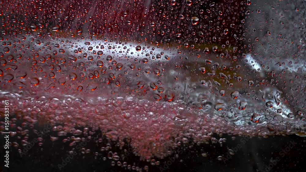 The texture of the water is a rumbling chaos with bubbles created by the air escaping outside in the blue light.