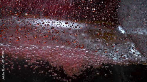 The texture of the water is a rumbling chaos with bubbles created by the air escaping outside in the blue light.