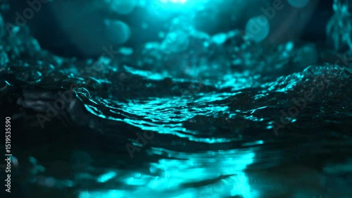 The texture of the water is a rumbling chaos with bubbles created by the air escaping outside in the blue light.