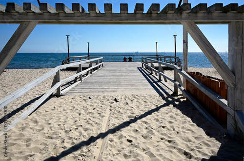Fototapeta Naklejka Na Ścianę i Meble -  Sopot, Pomerania, Poland, Europe - peaceful sandy beach with Mini molo near entrance nr 5 to the beach and restaurant Koliba, Sopot Kamienny Potok, Park Północny, Gdańsk Bay, Baltic Sea, end of June