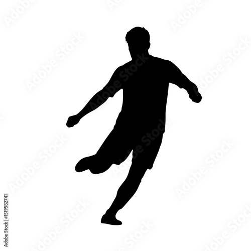 Silhouette of a soccer player kicking