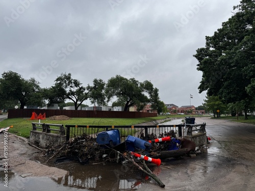 Wallpaper Mural Flood debris is pinned to a guardrail after flood waters receded. Damage from a flooding event in a residential neighborhood after severe rains. Insurance claim aftermath from flood Torontodigital.ca