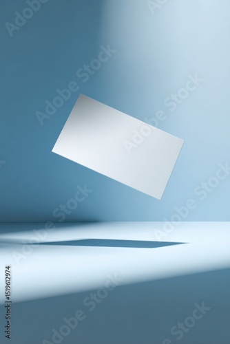 Business card mockup floating gracefully above a serene desk, illuminated by soft backlight, capturing minimalist elegance and creativity