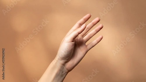 Elegant Female Hand Gestures on Beige Background: Studio Shot Demonstrating Hand Movements