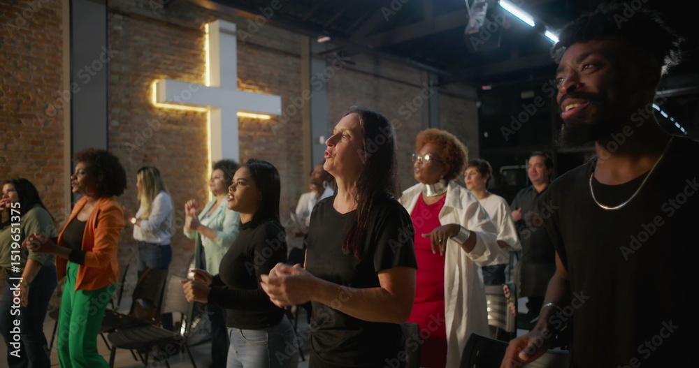 Obraz premium Diverse group of people clapping and smiling during worship in a church, glowing cross in background, expressions of joy, unity, and spiritual connection