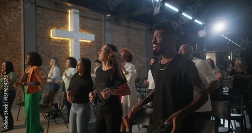 Φωτογραφία Multicultural congregation clapping and smiling during church worship, illuminat