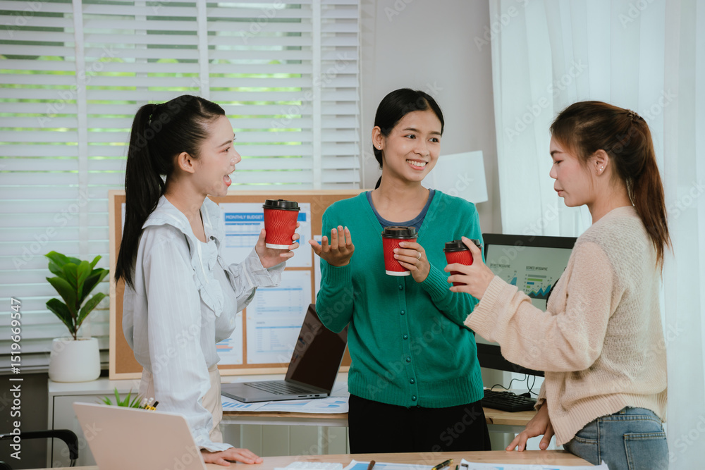 Fototapeta premium Diverse business team in modern office collaborating on startup strategy, analyzing charts, discussing growth, and planning successful marketing project.