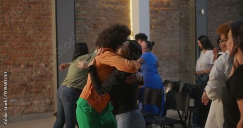 Schilderij op canvas Diverse congregation members exchanging hugs and smiles in a modern church setti