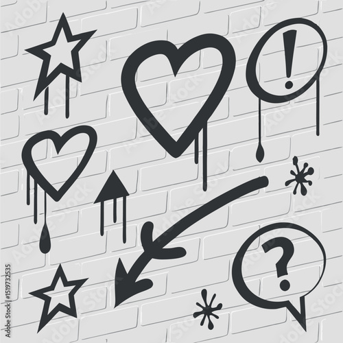 Graffiti style black icons and symbols sprayed on a white brick wall background