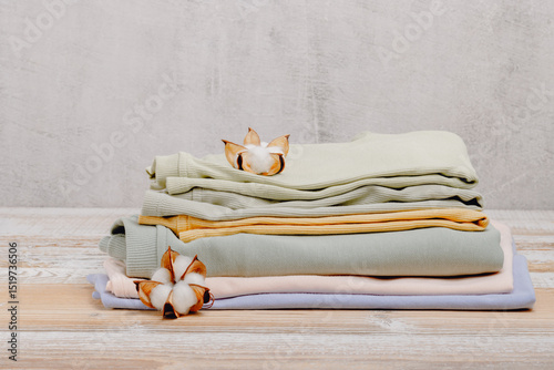 Pile of colorful cotton clothes with cotton flowers