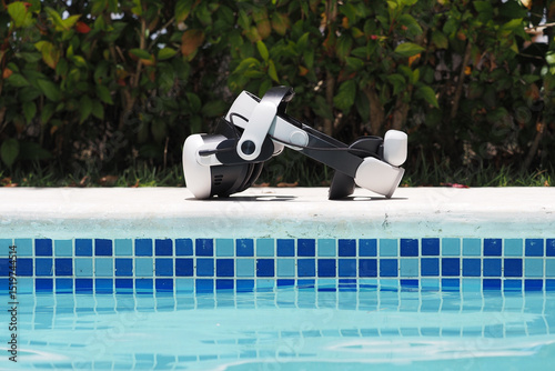 XR virtual reality headset rest outside near swimming pool.
