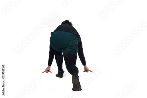 back view of a woman wearing shorts in starting position for a race.