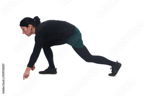 side view of a woman wearing shorts in starting position for a race.