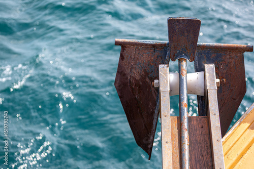 Anchor on the side of a boat at sea
