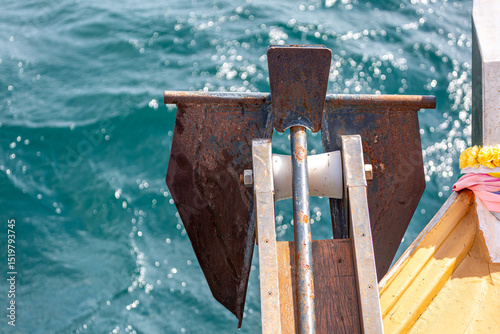 Anchor on the side of a boat at sea