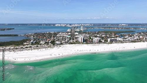 Beautiful aerial cinematic view of Sarasota, the magnificent white sand beach, and its iconic St. Armands Circle