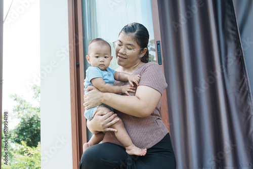 At home, a baby plays with their parents and aunt, sharing moments of laughter and occasional tears. The lively atmosphere reflects the warmth, joy, and emotional ups and downs of family life.
