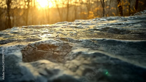 Frozen rock face at sunrise in a forest