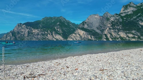 Drone view of northern Lake Garda near Torbole, Linfano. Surrounded by mountains, clear turquoise water, beaches, campings, and Monte Brione—perfect for nature, sport, and summer vacations