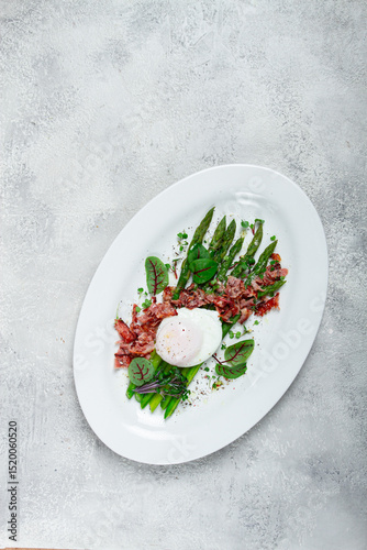 asparagus with poached egg and fried bacon, micro greens and spices, breakfast, homemade, no people,
