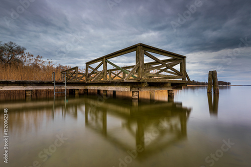 Fototapeta Naklejka Na Ścianę i Meble -  Wooden pier at a calm lake in Mazury, Poland.
