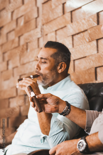 Hispanic men tasting cigars in a cigar lounge