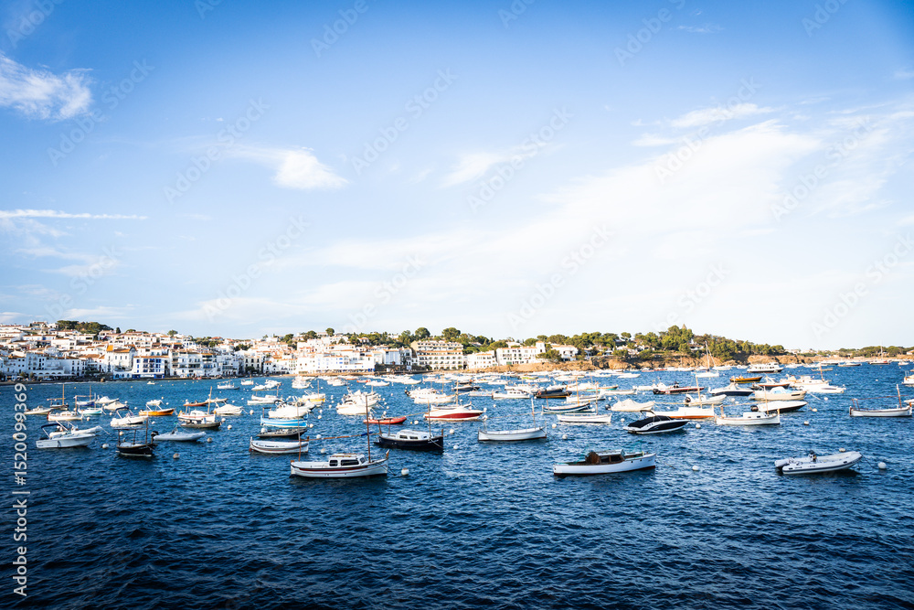 Obraz premium View of Cadaques, charming town in Catalonia, Spain. Mediterranean city on a bay with boats floating