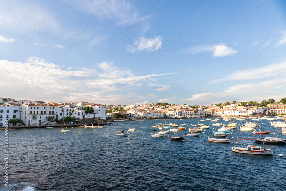 Fototapeta premium View of Cadaques, charming town in Catalonia, Spain. Mediterranean city on a bay with boats floating